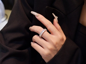 Close-up of S925 sterling silver eternity ring with baguette-cut stones on a hand