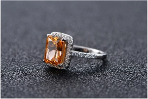 Macro side view of an 8x10mm radiant cut orange gemstone ring in 925 sterling silver