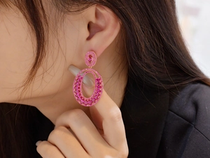 Close-up of pink tourmaline silver earrings with gold plating on female model