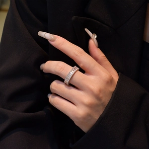Sterling silver eternity ring featuring rectangular-cut crystals worn by a model