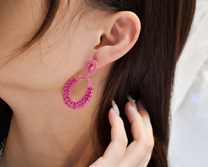 Macro detail of luxury pink tourmaline earrings on model showing vibrant stones