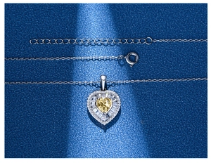Macro shot of 925 silver heart necklace with yellow gem and adjustable extension chain