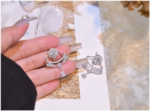 Detailed view of S925 silver fan-shaped drop earrings with sparkling cubic zirconia
