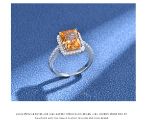 Macro detail of radiant cut orange stone ring in 925 sterling silver halo setting