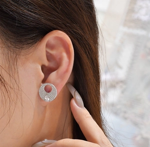 Detail of S925 sterling silver ear stud featuring a pavé circle and pear-cut drop stone