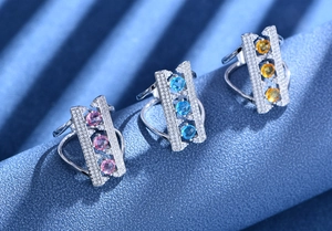 Detailed macro of S925 silver bridge rings with pink blue and yellow gemstones