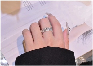 Detail of 925 sterling silver chain link ring with baguette and round cut zircons