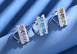 Macro shot of 925 silver bridge rings featuring geometric cutouts and colorful zircons