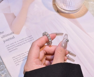 Close-up of a silver eternity ring with sparkling round-cut crystals in a modern style