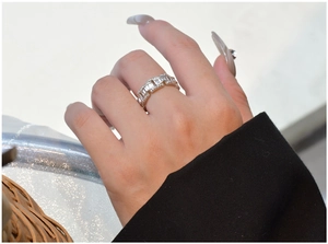 Detailed view of sterling silver chain ring set with sparkling zirconia on model hand
