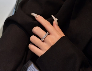 Detail of 925 sterling silver eternity band with sparkling stones on hand