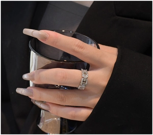 Detail view of 925 silver chain ring with zircon stones on a model's finger