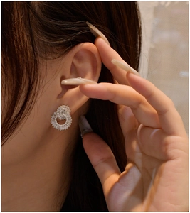 Detail of 925 sterling silver double hoop earrings with rectangular baguette zircons