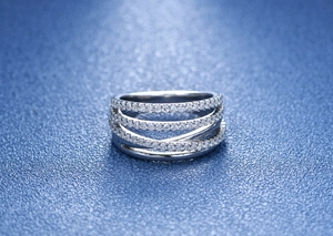 Close-up of multilayered crisscross ring with pavé diamond setting in S925 sterling silver