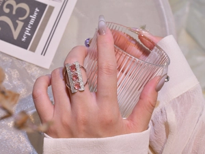 Detail of 925 sterling silver bridge ring with pink stones and diamonds on model finger