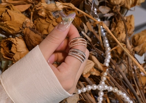Detail of wide multi-layer S925 silver rings with pavé diamonds in rose gold and silver
