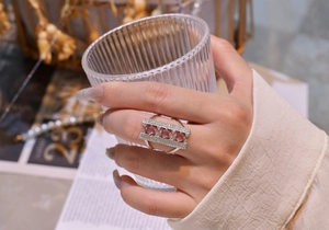 Close-up of 925 silver bridge ring featuring pink gemstones and pave white zircon