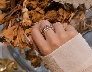 Detail of a triple-layer silver-plated ring set with sparkling zircon in an elegant style
