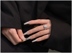 Close-up of crown clover ring in 925 silver with sparkling zircons worn on model's hand
