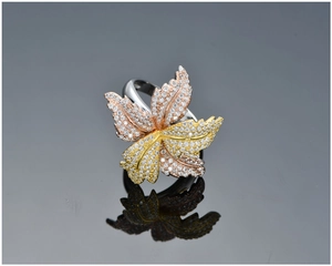 Detailed view of tricolor S925 silver leaf ring with pavé-set diamonds and textures