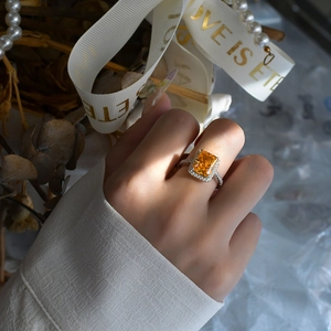 Radiant cut 7ct yellow gemstone halo ring in 925 sterling silver worn by model
