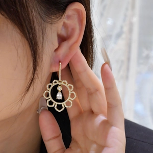 Elegant gold flower drop earrings with hollow design and sparkling zircon stones