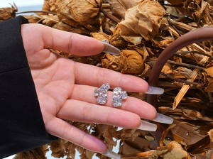 Detailed macro view of asymmetric 925 sterling silver studs with emerald-cut zircon stones