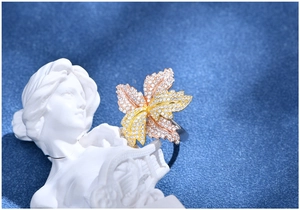 Macro detail of three-tone leaf ring with pavé-set stones on white plaster model