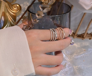 Close-up of stacked multi-layer zircon rings in silver and rose gold finishes