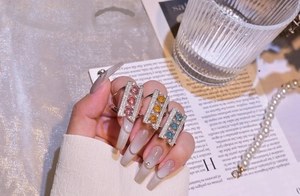 Close-up of three 925 silver rings with pink, yellow and blue oval gemstones set in pavé