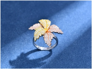 Macro detail of three-tone petal leaf ring with shimmering pavé set cubic zirconia