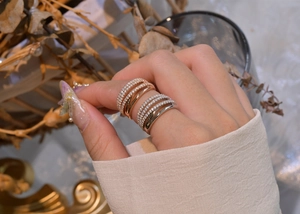 Detail of layered S925 silver ring set with micro-pave crystals and rose gold plating