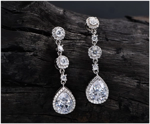 Macro shot of S925 silver long drop earrings with pear-cut halo gemstones