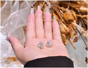 Macro view of 925 silver U-shape studs with rectangular zircon and pave accents