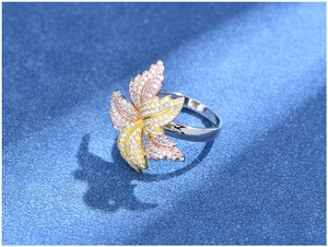 Detailed macro view of S925 silver tri-color flower ring with inlaid diamonds and petals