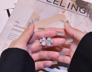 Detail of 925 sterling silver studs with emerald-cut cubic zirconia in a geometric cluster