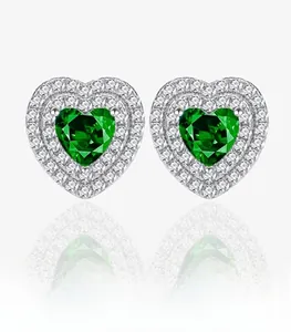 Detail of S925 sterling silver heart-shaped emerald stud earrings with double diamond halo