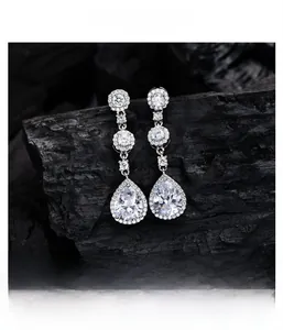 Macro detail of S925 silver pear-shaped drop earrings featuring halo-set zircon stones
