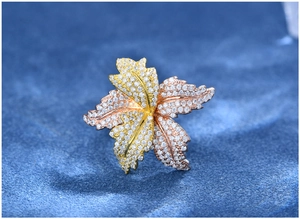 Macro detail of leaf ring showing tri-color gold plating and micro-pave white zircons