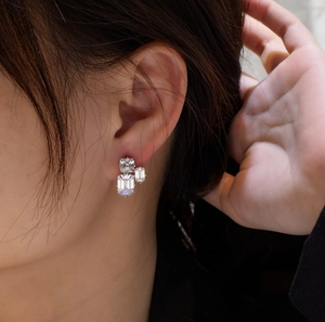 Macro shot of 925 silver stud earrings with tiered emerald-cut cubic zirconia crystals