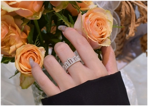 Detailed view of S925 sterling silver crown ring with zircon stones on a model hand