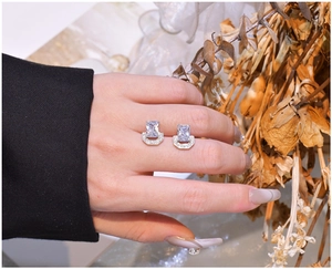 Detail of U-shape silver stud earrings with rectangular zircon and pave stones