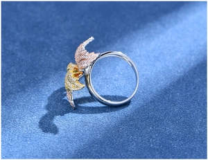 Macro view of tricolor leaf ring with cubic zirconia micro-pave on silver band