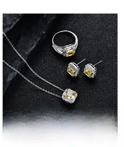 Macro detail of 925 sterling silver set featuring yellow radiant cut square gemstones