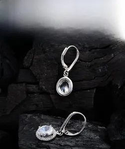 Macro shot of 925 silver earrings with 7x9mm oval 5A zircon in a pavé-set halo design