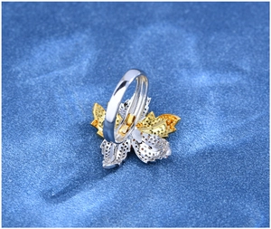 Macro view showing floral leaf ring with tri-color plating and micro-pave zircons