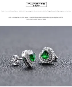 Macro shot of S925 sterling silver heart-shaped emerald stud earrings with white zircons