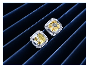 Macro shot of 925 silver square yellow diamond earrings on blue velvet background