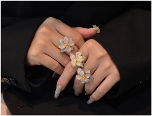 Detailed close-up of three tricolor S925 silver flower rings with sparkling zircon pavé