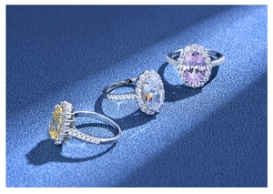 Close-up of three S925 silver halo rings with pink, white, and yellow oval gemstones